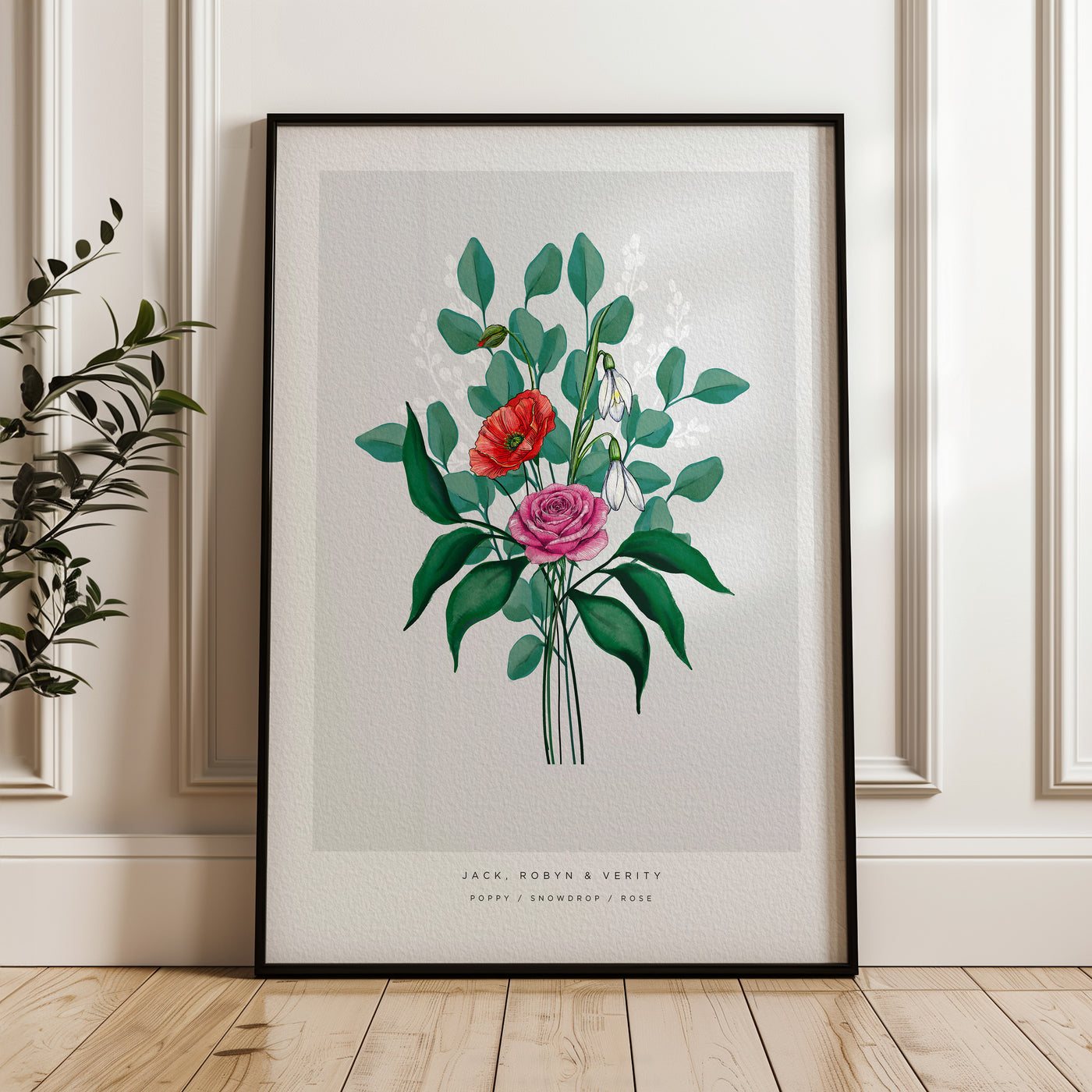 Familjebukett med månadsblommor i svart ram